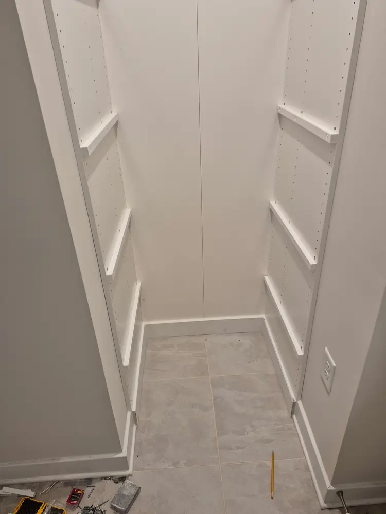 Closet uprights mounted and levelled before the shelves