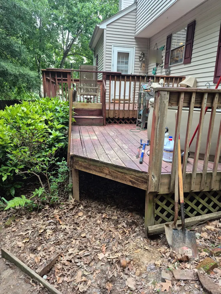 Weathered deck boards and railing before repainting