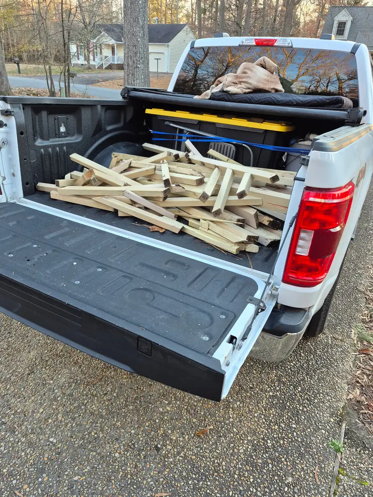 Pressure-treated lumber loaded in the truck bed for the railing build